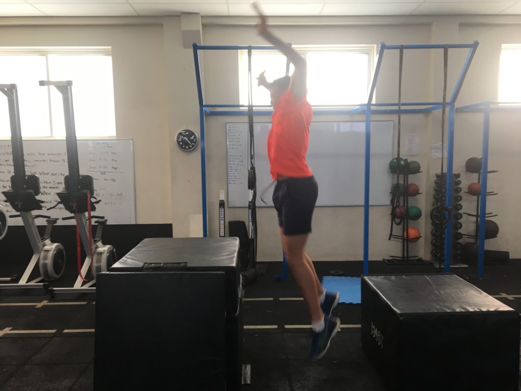 Zahn demonstrating depth jumps to improve vertical jump and power at Vector Health