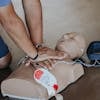 Hands of Person Doing CPR on Training Dummy